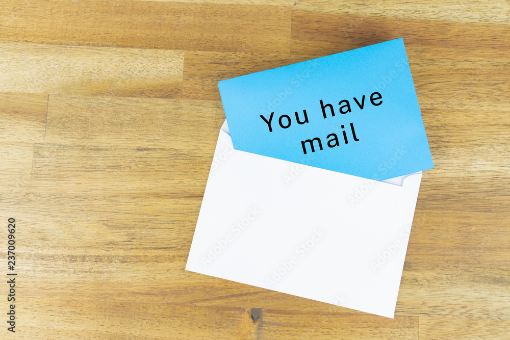 Envelope with a blue note with the words for you have mail Envelope with a blue note with the words for you have mail