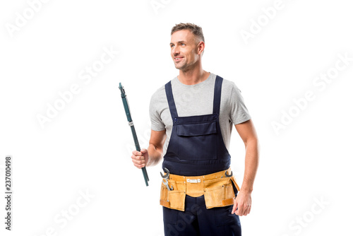 smiling plumber holding pipe wrench isolated on white