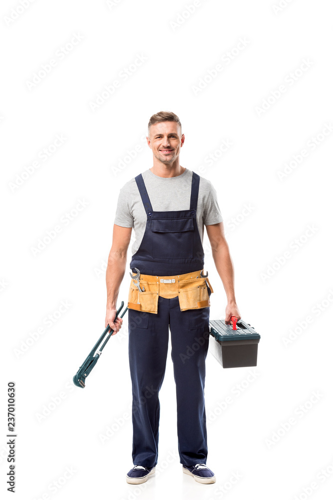 handsome worker holding pipe wrench and tool box isolated on white handsome worker holding pipe wrench and tool box isolated on white