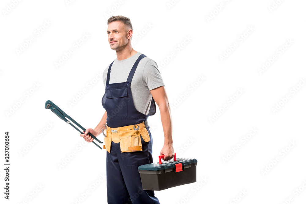 handsome worker holding pipe wrench and tool box isolated on white handsome worker holding pipe wrench and tool box isolated on white