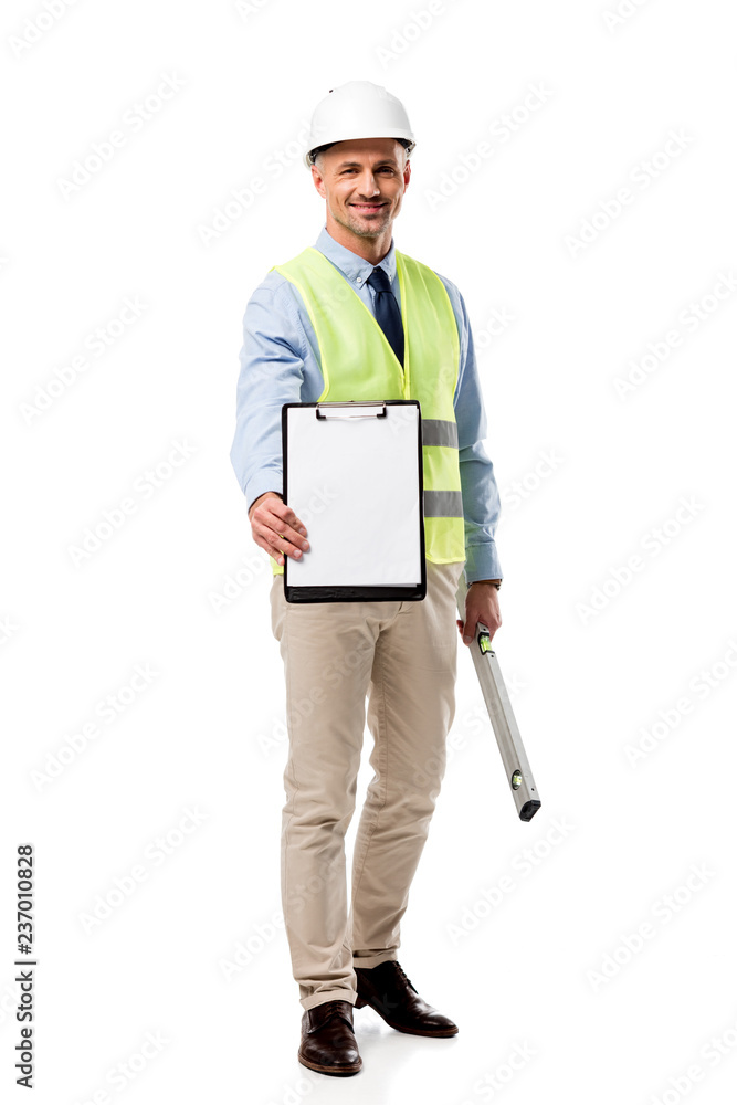 smiling engineer holding clipboard with blank sheet and spirit level isolated on white smiling engineer holding clipboard with blank sheet and spirit level isolated on white