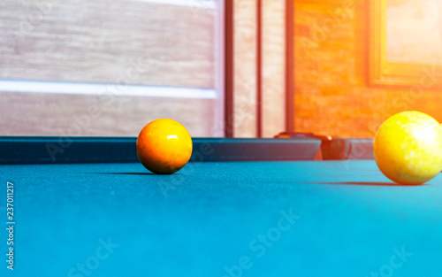 Billiard table close up. Playing billiard. Billiards balls and cue on green billiards table. Billiard sport concept. Pool billiard game.