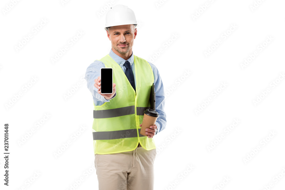 handsome engineer holding smartphone with blank screen and coffee to go isolated on white handsome engineer holding smartphone with blank screen and coffee to go isolated on white