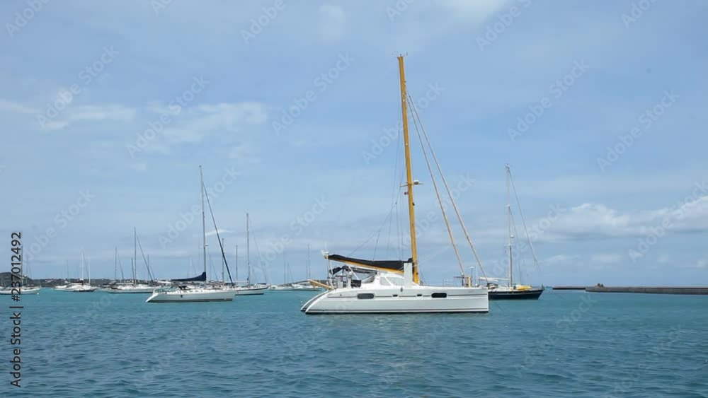 Boats in marina at Marigot, Saint Martin, Caribbean. Catamaran in the foreground. Boats in marina at Marigot, Saint Martin, Caribbean. Catamaran in the foreground.
