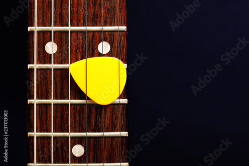 Guitar pick between strings