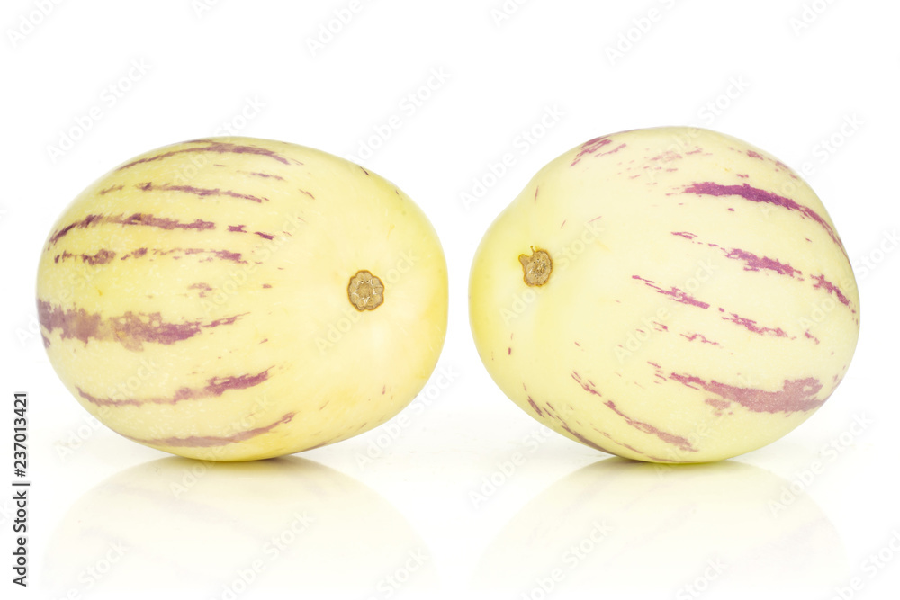 Group of two whole ripe light yellow fresh striped pepino melon isolated on white background Group of two whole ripe light yellow fresh striped pepino melon isolated on white background