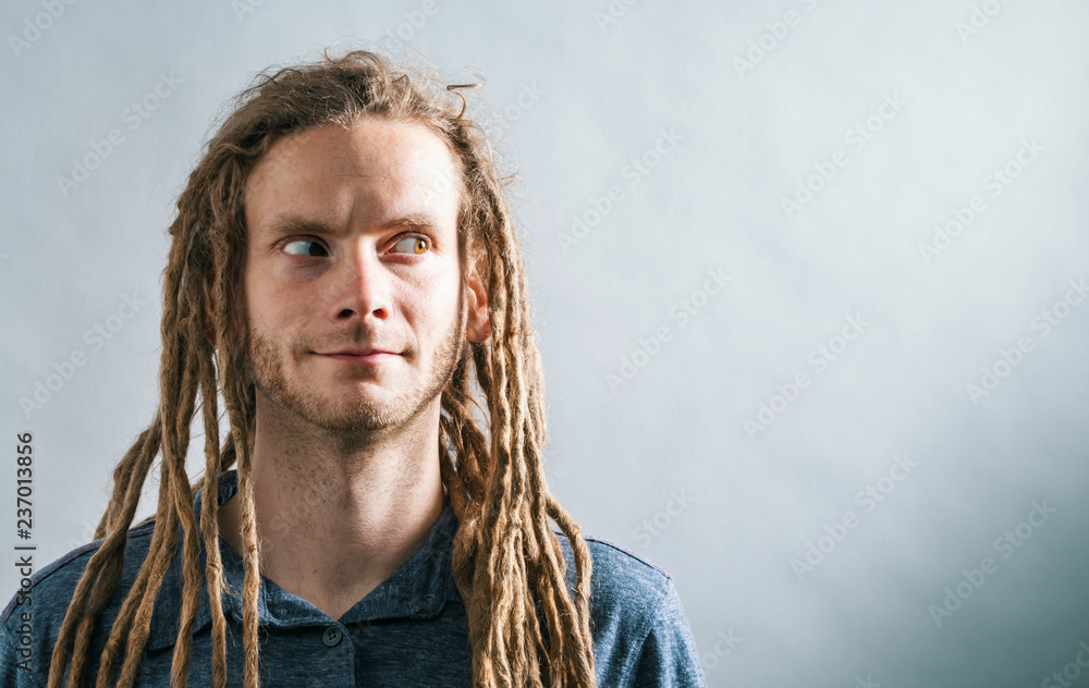 Portrait of a young man standing against a solid background Portrait of a young man standing against a solid background
