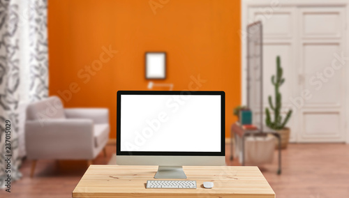 Desktop screen and blur orange background, interior. © UnitedPhotoStudio