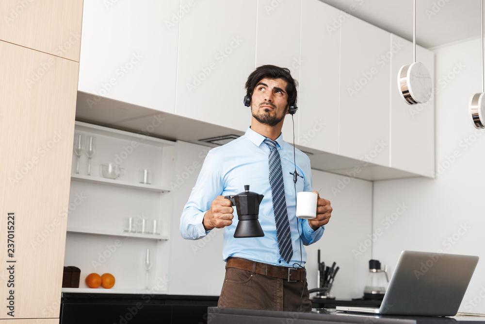 Confident young businessman working at home