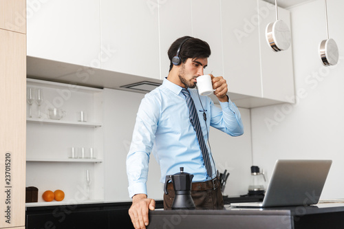 Confident young businessman working at home