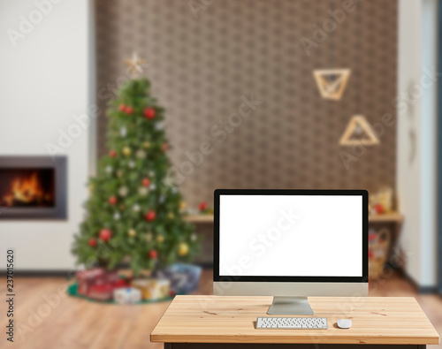 Christmas living room, modern living room and desktop screen on the desk. © UnitedPhotoStudio