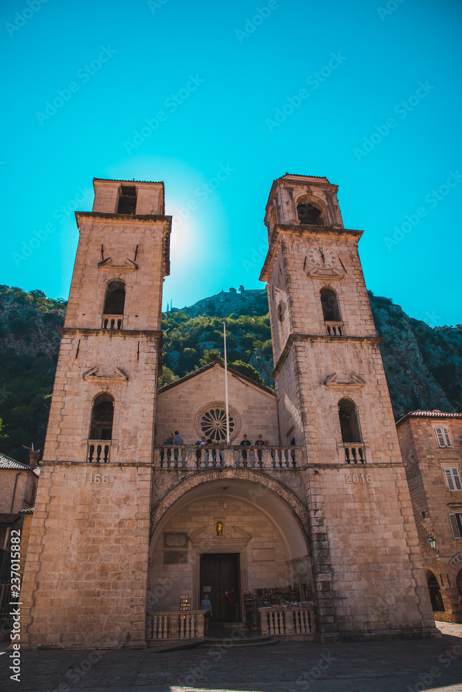 KOTOR, MONTENEGRO - July 20, 2018 old church with two towers and tourists on it