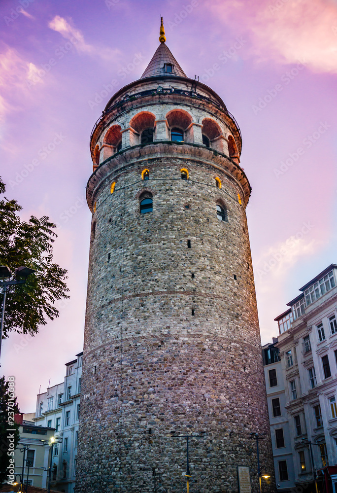 Galata Tower at purple night. Historical building or structure in Istanbul, Turkey. Beautiful view of old Galata Tower in twilight. One of the most famous and top rated tourist attraction in Istanbul.