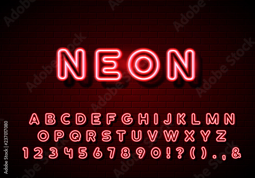 Neon alphabet typeset. Neon glow letters set on brick wall background.