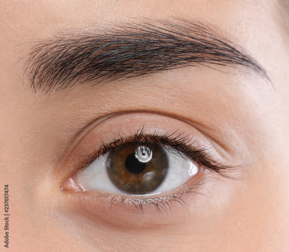 Closeup view of beautiful young woman with natural eyelashes Closeup view of beautiful young woman with natural eyelashes