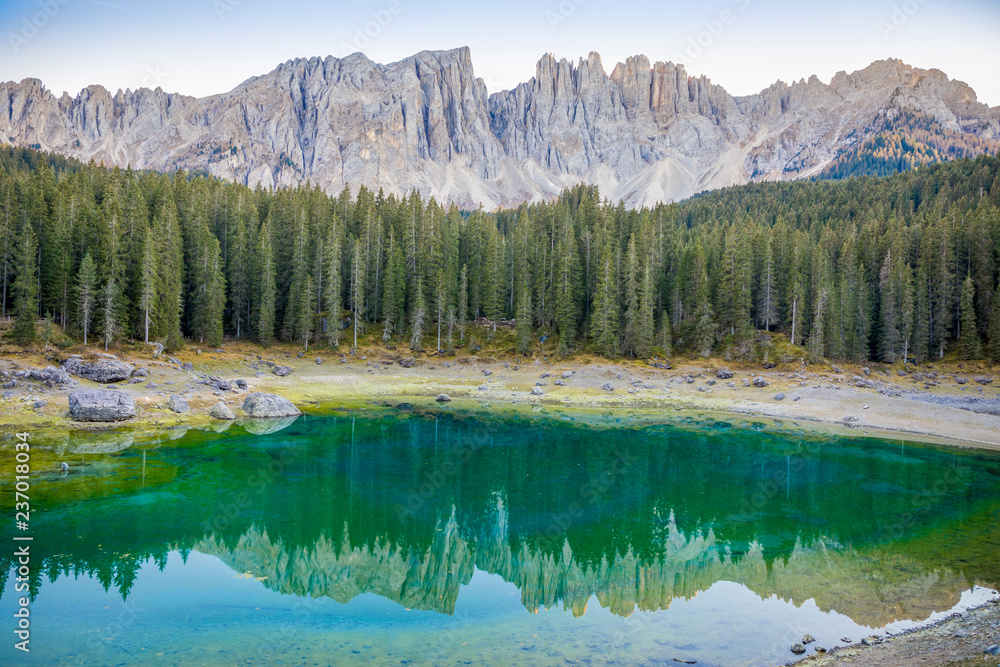 Karersee or Lago di Carezza, is a lake with mountain range of the Latemar group on background in the Dolomites in Tyrol, Italy