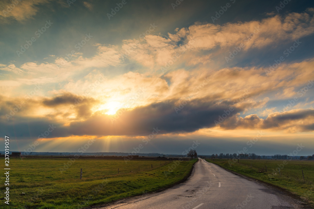 Sunrays over the country road