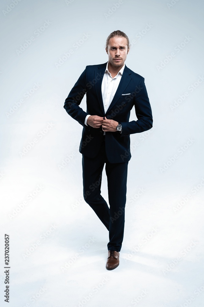 Perfect suit. Full length of handsome young man in suit looking at camera while standing against white background Perfect suit. Full length of handsome young man in suit looking at camera while standing against white background