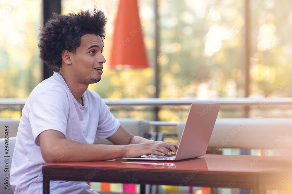 Image of african american businessman working on his laptop. Handsome young man at his desk. Image of african american businessman working on his laptop. Handsome young man at his desk.
