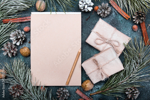 Christmas background with blank notebook surrounded by Christmas decorations. Letter to Santa or Christmas shopping list