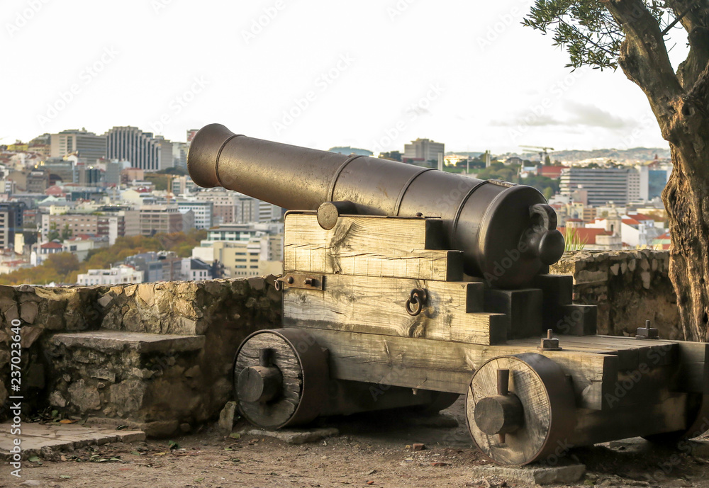 Old bronze cannon on wooden stand in castle of Lisbon, Portugal