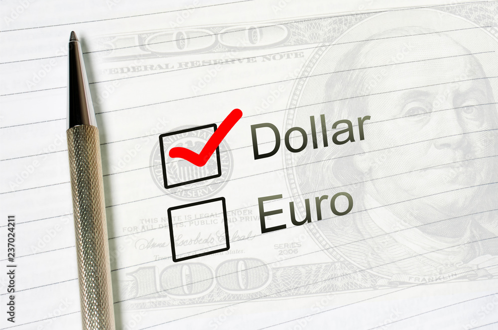 dollar choice or euro, marked check box with a pen on lined paper background. Investment trust concept dollar choice or euro, marked check box with a pen on lined paper background. Investment trust concept