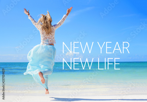 New year new life quote on the image of woman jumping in the air on the beach.