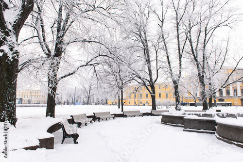 Wallpaper Mural Snowy winter day in the city. Winter city park with benches, covered with snow Torontodigital.ca