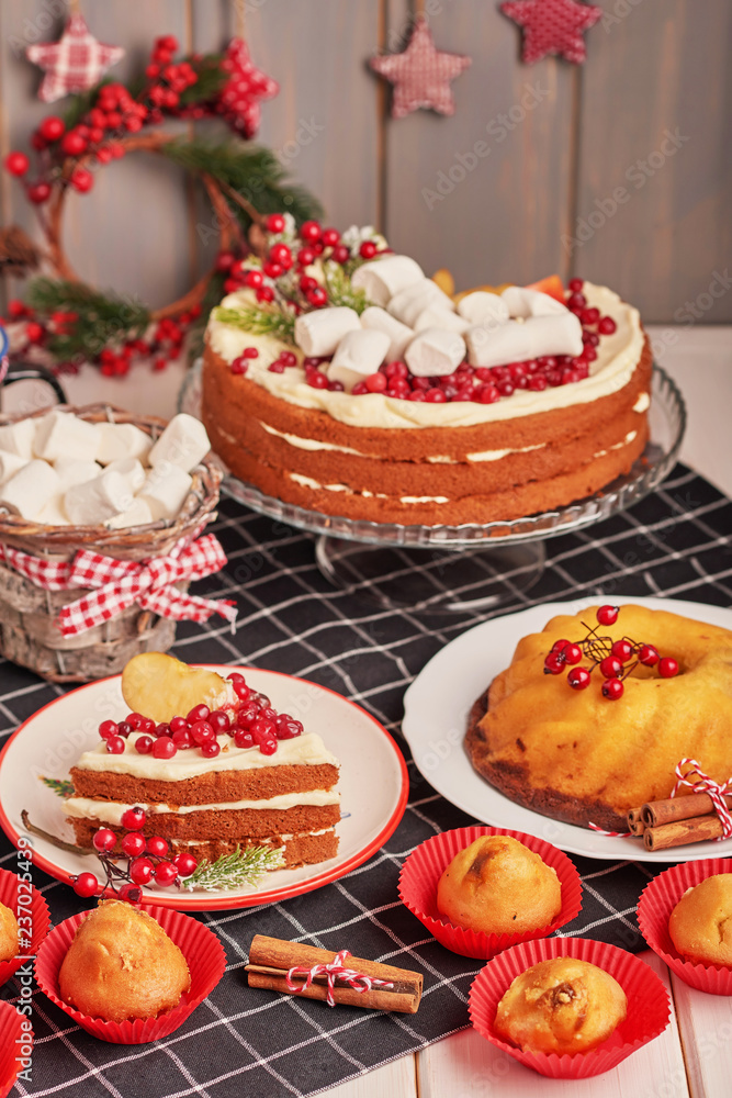 Christmas cake and sweets on table. Christmas  decorations with lights background. Happy New Year! Christmas greeting card. Winter card template. Xmas concept. Holiday Banner. Feast of Nativity. 