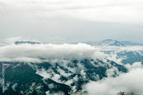 clouds floating over the mountain range, seen from the Zero Point, after a long trek through the forest in Binsar Wildlife Sanctuary, rainy season