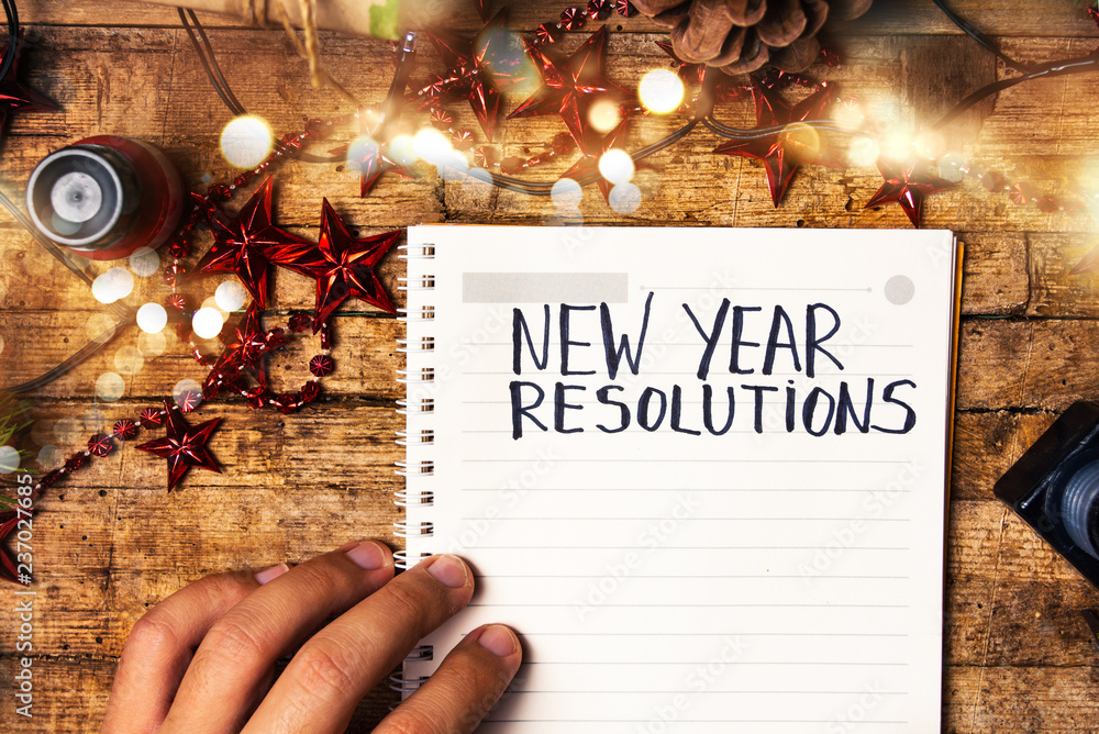 Fotografie Person writing new year resolutions