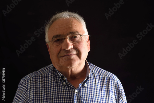 Portrait of a senior man with black background