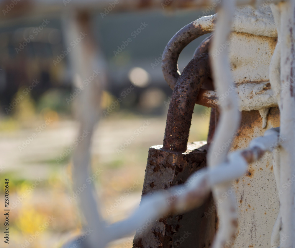 Old rusty padlock closes the gate Old rusty padlock closes the gate