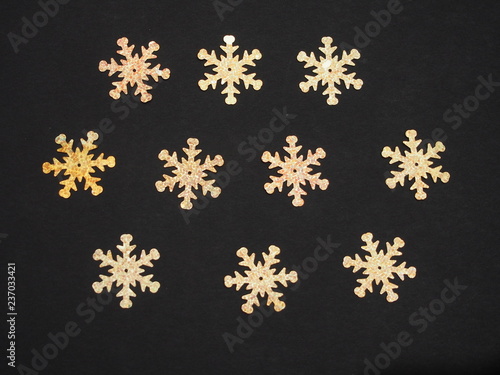 Colorful shiny stars on a black background. Winter background.