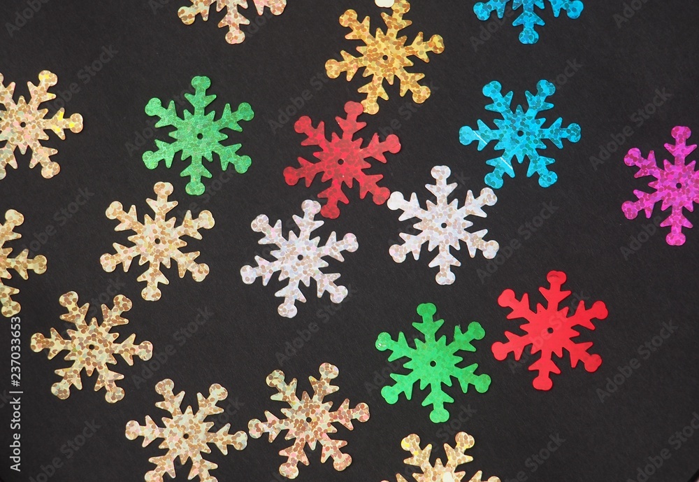 Colorful shiny stars on a black background. Winter background. Colorful shiny stars on a black background. Winter background.