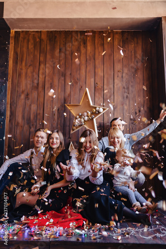 Friends play with confetti on New Year celebration, Home atmosphere, Christmas