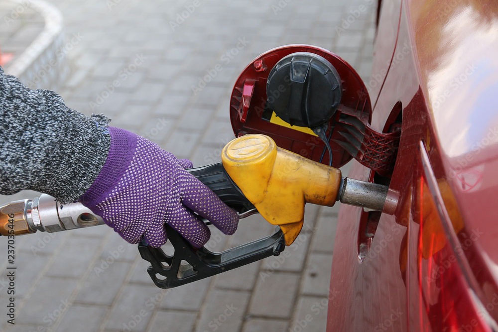 Fototapeta premium Hand holding a gasoline feed gun