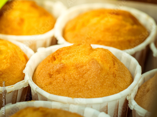 Vanilla muffins, paper cupcake holder, selective focus. Close-up photo of decorated homemade cupcakes in box. Gluten free almond flour muffin.