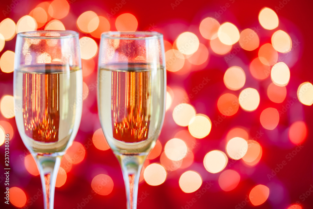 Champagne glasses on light bokeh red background Champagne glasses on light bokeh red background