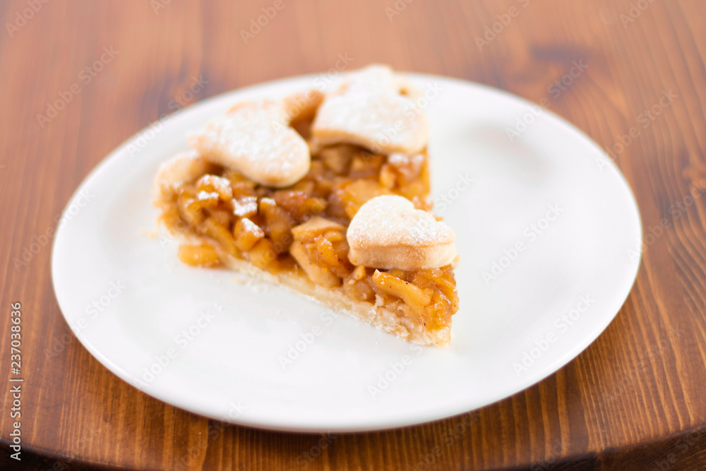 Apple pie served in glass service plate with isolated black background