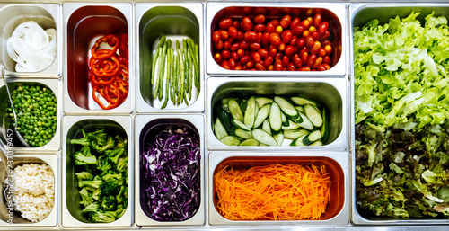 Top view of salad bar with assortment of ingredients for healthy and diet meal.