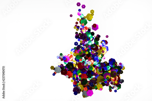 Multicolored shiny sequins on white background. Top view.