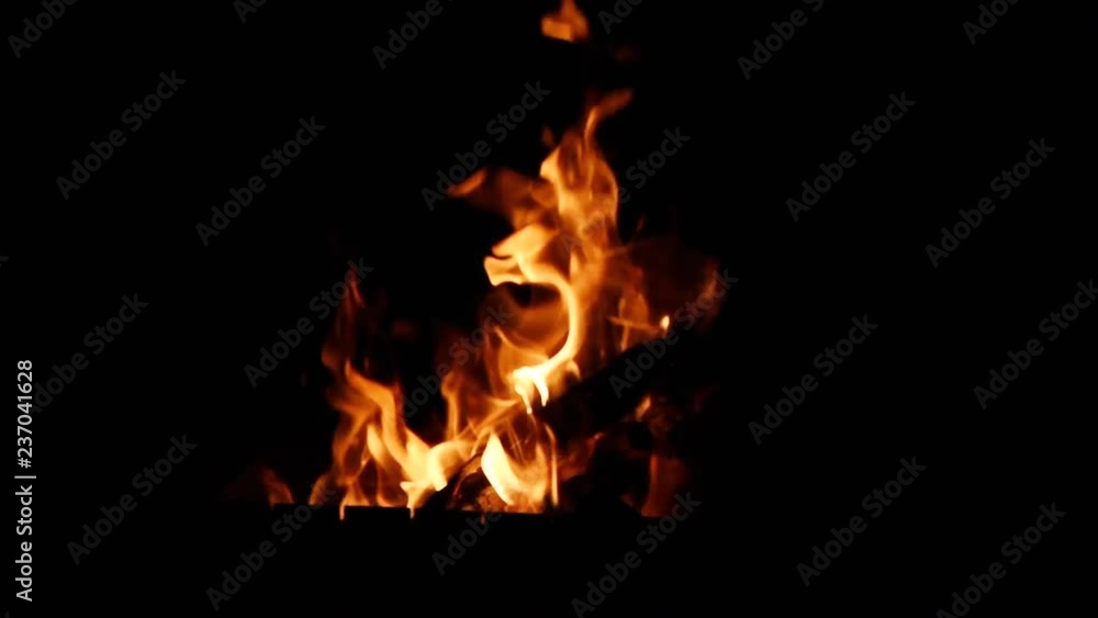bright orange and yellow flames on a black background, blurred focus bright orange and yellow flames on a black background, blurred focus