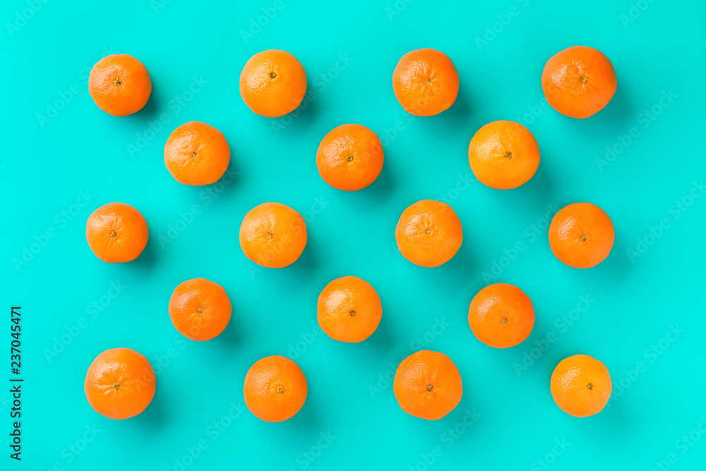 Fruit pattern of mandarin isolated on blue background. Tangerine. Flat lay, top view. Fruit pattern of mandarin isolated on blue background. Tangerine. Flat lay, top view.