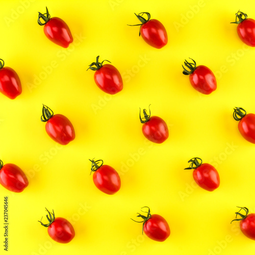 Food pattern of cherry tomato  isolated on yellow background. Flat lay, top view.