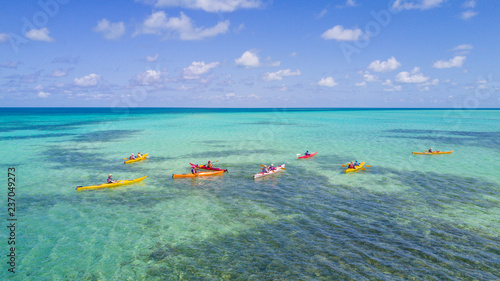 Aerial view of tropical island at Glover's Reef Atoll in Belize with a group of kayakers