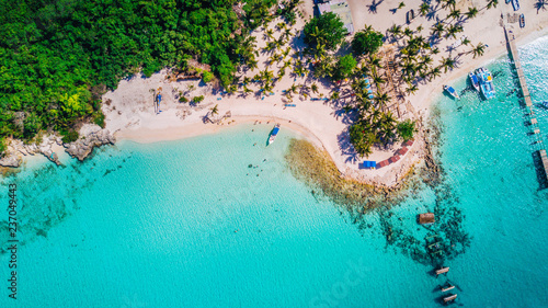 Aerial drone view of Saona Island in Punta Cana, Dominican Republic with reef, trees and beach in a tropical landscape with boats and vegetation photo