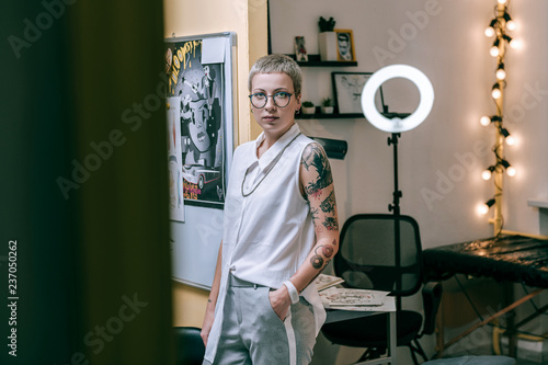 Attractive woman with unusual appearance working as tattoo master