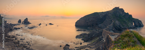 Famous Gaztelugatxe rock with a really nice sunset at July next to Bermeo and Bakio at the Basque Country. photo
