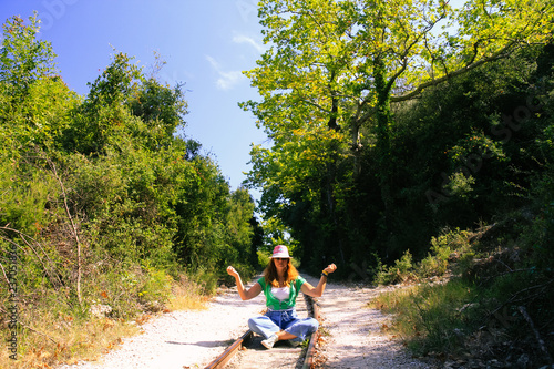 Woman doing yoga on rail tracks